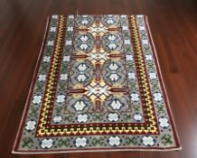 A woolen rug of Eastern design, 168 cm x 125 cm.