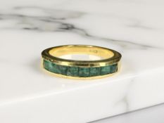 An 18ct gold emerald half-eternity ring,