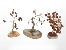 Three oriental polished hardstone and glass miniature trees, tallest 12 cm.