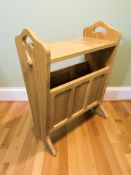 A Coxwold Cabinet Makers oak magazine rack with carved unicorn signature,