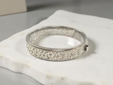 A silver bangle with engraved decoration CONDITION REPORT: 16.