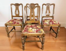 A set of four carved oak dining chairs.