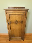 An early 20th century oak single door cabinet, 66 cm x 46 cm x 122 cm.