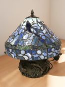 A Tiffany-style stained glass and bronze effect table lamp, height 41 cm.