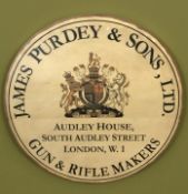 A reproduction James Purdey & Sons Ltd Gun and Rifle Makers circular wooden advertising plaque,