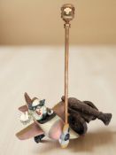 A painted wooden model of a clown in an aeroplane,