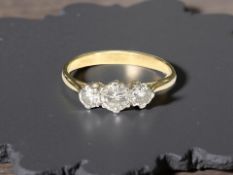 An 18ct yellow gold three stone diamond ring, size P. CONDITION REPORT: Weight: 2.9g.
