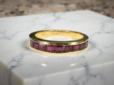 An 18ct gold ruby half-eternity ring,