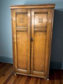 An Edwardian panelled oak two door gent's wardrobe, 95 cm x 49 cm x 174 cm.