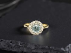 An 18ct yellow gold blue zircon and diamond ring, size N.