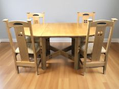 A contemporary oak Arts & Crafts style dining room suite comprising an extending dining table with