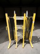 An aluminium extending ladder and a pair of enameled metal extendable barriers.