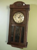 An early 20th century oak eight day wall clock, with silvered dial.
