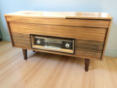 A teak cased radiogram, 126 cm x 39 cm x 71 cm.