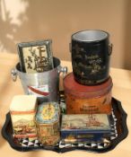 A lacquered metal tray, champagne bucket, several tins.