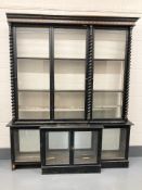 A Victorian ebonised and gilt highlighted break fronted shop display cabinet,