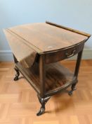 A mahogany drop leaf trolley on castors,