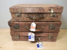 Three stitched leather luggage cases, width 68 cm.