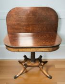 A reproduction mahogany turnover top tea table,