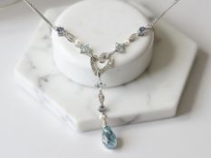 A 9ct white gold diamond, tanzanite and blue topaz pendant on chain.