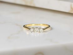 An 18ct gold and platinum three stone diamond ring, size O CONDITION REPORT: 1.