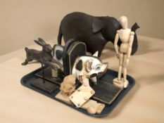 A pair of painted wooden bookends in the form of a pig, further animal figures,