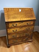 A reproduction mahogany bureau,