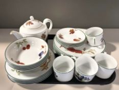 A Royal Worcester Evesham Vale four place service including teacups, bowls, dinner plates, teapot.
