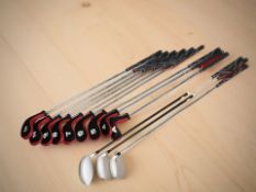 A group of golf clubs to include Slazenger and Woodworm.