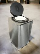 A stainless steel hot plate on castors.