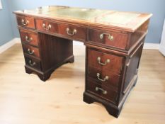 A reproduction yew wood twin pedestal desk, 122 cm x 62 cm x 77 cm.