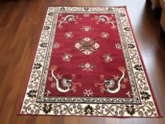 A machine made rug of Chinese design, 218 cm x 160 cm.