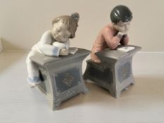 Two Nao figures of children reading, No. 1403 and 1404, height 16 cm.
