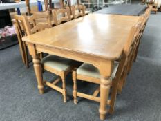 A contemporary oak dining table and set of six ladder back chairs, table 186 cm x 102 cm x 77 cm.