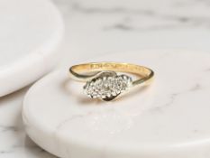 An 18ct gold and platinum diamond crossover ring, size J CONDITION REPORT: 1.