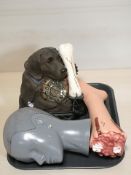 A novelty dog and bone telephone, a mannequin head and plastic foot.