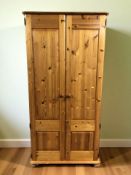 A modern pine double door wardrobe, 92 cm x 62 cm x 180 cm.
