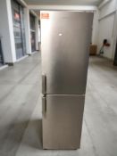 A Grundig brushed steel fridge freezer.