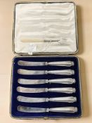 A set of six silver-handled butter knives in fitted case,