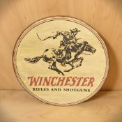 A reproduction Winchester Rifles and Shotguns wooden sign,