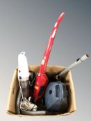 Three various vacuum cleaners.