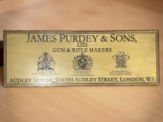 A reproduction James Purdey and Sons Gun and Rifle makers wooden sign,