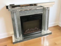 A contemporary mirrored fire surround with electric fire,