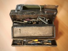 An antique joiner's tool box containing carpentry tools