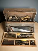 An antique joiner's tool box containing carpentry tools