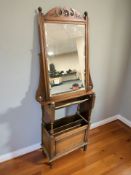 An oak magazine stand and a mahogany mirror