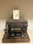 An antique Singer sewing machine in box