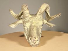A gold painted cast iron goat's head,