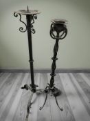Two wrought metal candle stands,