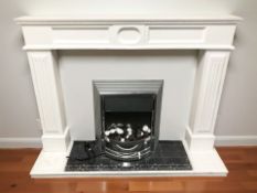 A contemporary fire surround with electric fire,